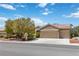 Inviting single-story home featuring a spacious three-car garage and meticulously maintained landscaping at 1629 Black Fox Canyon Rd, Henderson, NV 89052