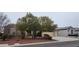 Charming single-story home featuring mature tree, desert landscaping, and a two-car garage at 1629 Black Fox Canyon Rd, Henderson, NV 89052