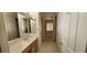 Bathroom hallway leads to bedroom featuring bright lighting and a closet at 1629 Black Fox Canyon Rd, Henderson, NV 89052