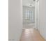 Hallway leading to a bedroom with white walls, tile flooring, and a ceiling fan at 1629 Black Fox Canyon Rd, Henderson, NV 89052