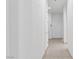 Hallway featuring neutral tile flooring and white walls leading to other rooms in the house at 1629 Black Fox Canyon Rd, Henderson, NV 89052