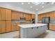 Spacious kitchen features a large island, stainless steel appliances, and lots of wooden cabinets at 1629 Black Fox Canyon Rd, Henderson, NV 89052