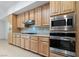 Close up of the kitchen with stainless steel appliances and wooden cabinets at 1629 Black Fox Canyon Rd, Henderson, NV 89052