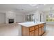 Open kitchen and Gathering room area with tile floors, stainless appliances, and a fireplace at 1629 Black Fox Canyon Rd, Henderson, NV 89052