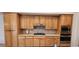 This kitchen includes natural wood cabinets, stainless steel appliances, and plenty of counter space for easy food preparation at 1629 Black Fox Canyon Rd, Henderson, NV 89052
