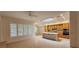 Bright kitchen features natural wood cabinets, a skylight, and a center island with sink, seamlessly connecting to the dining area at 1629 Black Fox Canyon Rd, Henderson, NV 89052