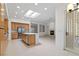 Spacious eat-in kitchen with stainless appliances, island, and view into the living room with fireplace at 1629 Black Fox Canyon Rd, Henderson, NV 89052