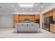Kitchen boasts wood cabinetry, stainless appliances, large island, and a bright skylight at 1629 Black Fox Canyon Rd, Henderson, NV 89052