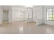 Bright living room featuring tile flooring, neutral paint, and ample natural light from large windows at 1629 Black Fox Canyon Rd, Henderson, NV 89052