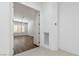 Open doorway leading to a spacious living room with wood flooring and modern ceiling fan at 1629 Black Fox Canyon Rd, Henderson, NV 89052