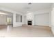 Open-concept living room showcasing a fireplace, tile flooring, and abundant natural light at 1629 Black Fox Canyon Rd, Henderson, NV 89052