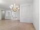 Bright and airy formal living room with neutral tile floors and an elegant chandelier at 1629 Black Fox Canyon Rd, Henderson, NV 89052