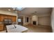 Bright living area shows fireplace and flows into kitchen with island and oak cabinets at 1629 Black Fox Canyon Rd, Henderson, NV 89052