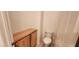 Powder room featuring a white toilet and wood cabinet at 1629 Black Fox Canyon Rd, Henderson, NV 89052
