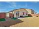 Backyard with grass, rock, and brick wall; adjacent to single-story home at 3716 W Colton Ave, North Las Vegas, NV 89032