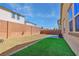 Backyard featuring a brick wall, rock landscaping, and a small grass area at 3716 W Colton Ave, North Las Vegas, NV 89032