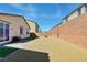 Backyard featuring a rock yard, grass area, and tall brick perimeter walls at 3716 W Colton Ave, North Las Vegas, NV 89032