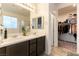 Bright bathroom features dual sinks, quartz countertop, and a walk-in closet at 3716 W Colton Ave, North Las Vegas, NV 89032