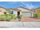 Charming single-story home features a well-manicured front yard, brick driveway, and attached two-car garage at 3716 W Colton Ave, North Las Vegas, NV 89032