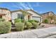 Attractive single-story home with mature landscaping, brick driveway, and neutral color palette at 3716 W Colton Ave, North Las Vegas, NV 89032