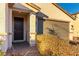 Close-up of the front door and brick driveway with manicured bushes and an attached garage at 3716 W Colton Ave, North Las Vegas, NV 89032