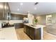 Bright kitchen with sleek countertops, stainless steel appliances, and center island overlooking living area at 3716 W Colton Ave, North Las Vegas, NV 89032