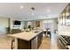 Open kitchen features a spacious island and stainless steel appliances, seamlessly connected to the living area at 3716 W Colton Ave, North Las Vegas, NV 89032