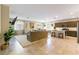 Spacious open-concept living area featuring tile floors, modern furnishings, and a gourmet kitchen at 3716 W Colton Ave, North Las Vegas, NV 89032