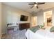 Comfortable main bedroom featuring a ceiling fan, a sewing station, and a walk-in closet at 3716 W Colton Ave, North Las Vegas, NV 89032