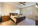 This spacious main bedroom features a ceiling fan, multiple windows, and coordinating furniture at 3716 W Colton Ave, North Las Vegas, NV 89032