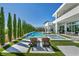 Relaxing backyard featuring a sleek pool, spa, stylish furniture, and manicured landscaping at 9760 Solar Ave, Las Vegas, NV 89149