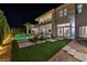 Expansive backyard with pool, spa, lounge area, covered patio, manicured artificial turf, and lush greenery at 9760 Solar Ave, Las Vegas, NV 89149