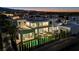 Aerial view of a modern home's backyard oasis with pool, patio, and privacy landscaping illuminated at dusk at 9760 Solar Ave, Las Vegas, NV 89149