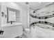 Modern bathroom with marble accents, a sleek vanity, and a combined tub and shower at 9760 Solar Ave, Las Vegas, NV 89149