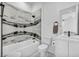 Elegant bathroom showcasing marble tile, contemporary fixtures, and a separate tub and shower at 9760 Solar Ave, Las Vegas, NV 89149