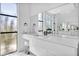 Modern bathroom featuring dual vanities, sleek countertops, and large windows at 9760 Solar Ave, Las Vegas, NV 89149