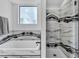 Elegant bathroom featuring a soaking tub, a separate shower, and modern finishes at 9760 Solar Ave, Las Vegas, NV 89149