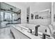 Modern bathroom featuring a soaking tub with marble surround and dual vanities at 9760 Solar Ave, Las Vegas, NV 89149