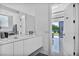 Spacious bathroom featuring double sinks, vanity, and large window with outdoor views at 9760 Solar Ave, Las Vegas, NV 89149