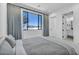 Bright bedroom with a large window and a scenic view, featuring modern gray and white decor at 9760 Solar Ave, Las Vegas, NV 89149