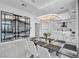 Dining room showcases a modern chandelier, marble wine storage, and open floor plan to kitchen at 9760 Solar Ave, Las Vegas, NV 89149