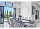 Open dining area features modern lighting and view of a well-manicured yard and pool area at 9760 Solar Ave, Las Vegas, NV 89149