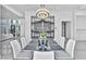 Bright dining room features a modern chandelier, marble wine storage, and pool views at 9760 Solar Ave, Las Vegas, NV 89149