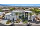 Eye-catching modern home with stylish landscaping, featuring palm trees and clean lines with a picturesque mountain view at 9760 Solar Ave, Las Vegas, NV 89149