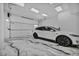 Spacious garage featuring a clean epoxy floor, overhead lighting, and room for parking at 9760 Solar Ave, Las Vegas, NV 89149