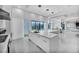Bright, white kitchen with quartz counters, pendant lighting, and large island with bar seating at 9760 Solar Ave, Las Vegas, NV 89149