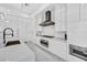 Modern kitchen features sleek white cabinetry, stainless steel appliances, and a large island at 9760 Solar Ave, Las Vegas, NV 89149