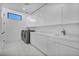 Well-lit laundry room featuring modern appliances, ample storage, and a convenient utility sink at 9760 Solar Ave, Las Vegas, NV 89149
