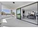 Elegant living room with large sliding glass doors opening to a balcony with mountain views at 9760 Solar Ave, Las Vegas, NV 89149