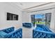 Cozy living area with stylish blue seating overlooking a well-manicured outdoor pool area at 9760 Solar Ave, Las Vegas, NV 89149